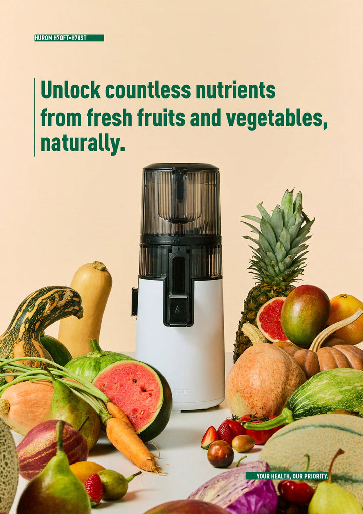 Black and white Hurom H410 slow juicer surrounded by fruits and vegetables with text about unlocking nutrients.