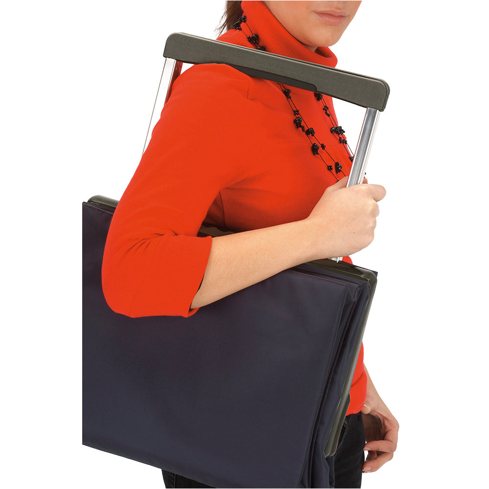 A black folded Rolser Plegamatic shopping trolley being carried by a lady.