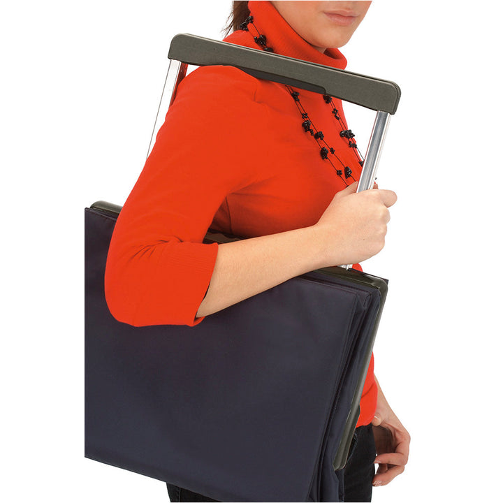 A black folded Rolser Plegamatic shopping trolley being carried by a lady.