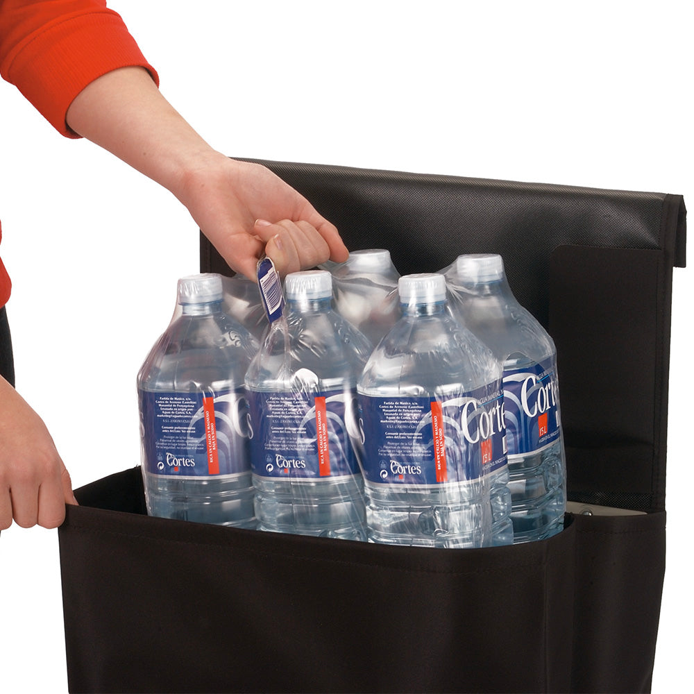 A black foldable Rolser Plegamatic shopping trolley being filled with a carton of 1.5L water.
