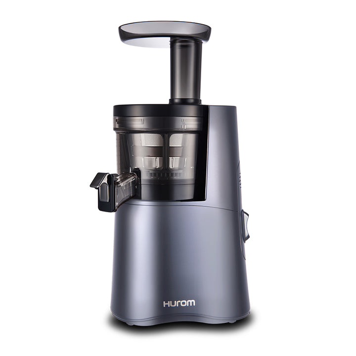 A Hurom HA-2600 Classic Series slow juicer in blue color, showing the juicer's chamber and the pusher.